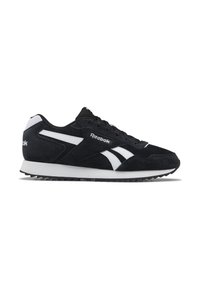 Baskets en suède noir avec des accents blancs, dotées d'un design classique basse, d'un système de laçage et d'une semelle en caoutchouc texturé. Marquage Reebok visible.