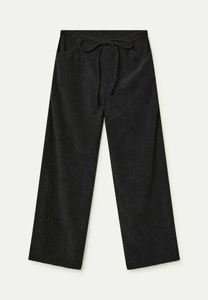 Pantalones de pana anchos y negros con cinturilla elástica y cordón, que cuentan con bolsillos frontales.