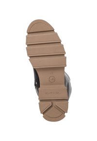 Suola nera di scarpa con fondo in gomma marrone testurizzato. Presenta multiple scanalature e creste orizzontali per una maggiore aderenza. Taglia contrassegnata come 37.