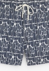 Shorts de bain en tissu léger avec un motif géométrique bleu marine et blanc. Taille élastique avec cordon de serrage ajustable.