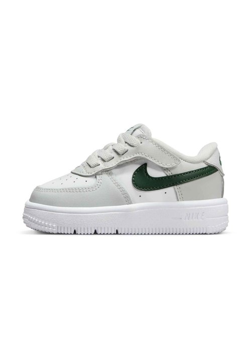 Nike-tennarit valkoisesta ja vihreästä nahasta, matalavartinen malli, teksturoitu pinta, valkoinen kumipohja ja nauhat. Sisältää ikonisen swoosh-logon.