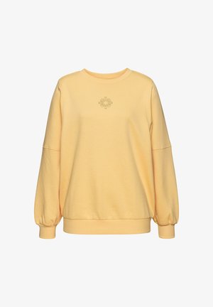 Felpa gialla chiara con scollatura rotonda, maniche lunghe a sbuffo, polsini a costine e un motivo a sole centrale. Tessuto morbido e texturizzato.