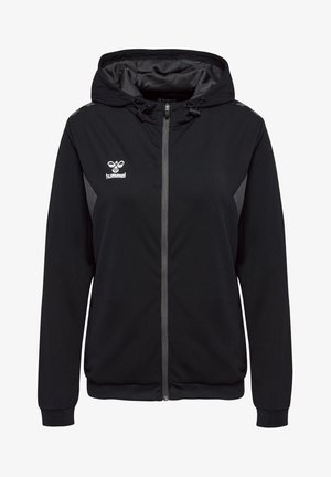 Zwarte hoodie met een rits aan de voorkant, contrasterende grijze zijpanelen en het Hummel-logo op de borst. Gemaakt van een gestructureerde stof.