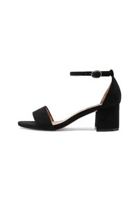 Sandali con tacco in suede nero, con cinturino alla caviglia, tacco a blocco, punta aperta e design minimalista. Suola piatta e texture liscia.