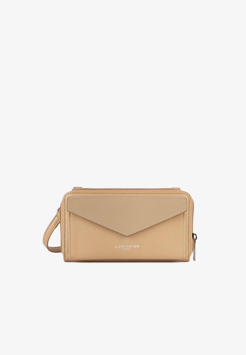 Sac bandoulière en cuir beige avec une finition texturée, un design de rabat géométrique et un logo en argent. Comprend une bandoulière amovible et une fermeture éclair.
