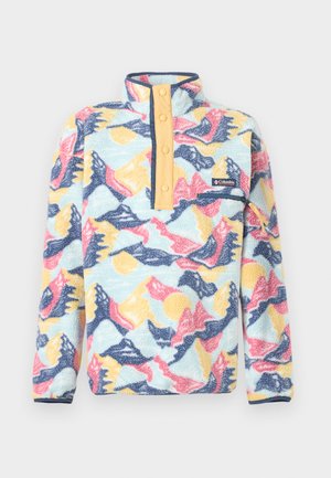 Fliša džemperis ar augstu apkakli, pirkstu aizdares pogām un abstraktu kalnu rakstu zilā, rozā, dzeltenā un gaiši zilā toņos, ar rāvējslēdzēja slēptu krūšu kabatu.