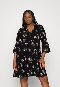 Black floral dress with three-quarter sleeves, ruffled tiers, and a V-neckline. Features a pattern of pink flowers and green leaves.