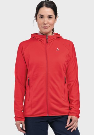 Red zip-up jacket with a hood and side pockets, featuring textured fabric and a logo on the chest. Tailored fit with long sleeves.