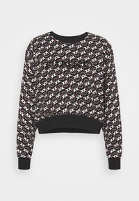 Czarna krótka bluza z nadrukiem w białe i czerwone wzory na całej powierzchni, z prążkowanymi mankietami i dekoltem. Miękka struktura tkaniny.