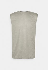 Débardeur de sport gris sans manches avec épaules rembourrées et petit logo Nike Swoosh noir sur le haut du côté droit de la poitrine.