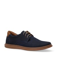 Navy perforated leather shoes with a brown leather accent, lace-up design, and a light brown rubber sole.