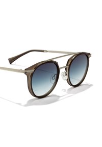 Kulaté sluneční brýle s tmavě hnědým plastovým rámem, stříbrnými kovovými rameny a modrými čočkami s přechodem. Mají nosníky pro pohodlí.