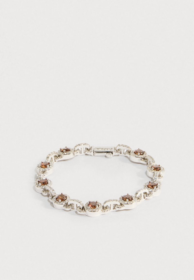 Ezüst karkötő kerek barna drágakövekkel, melyeket kis tiszta kristályok vesznek körül, körkörös és hullám alakú mintákban összekapcsolva.