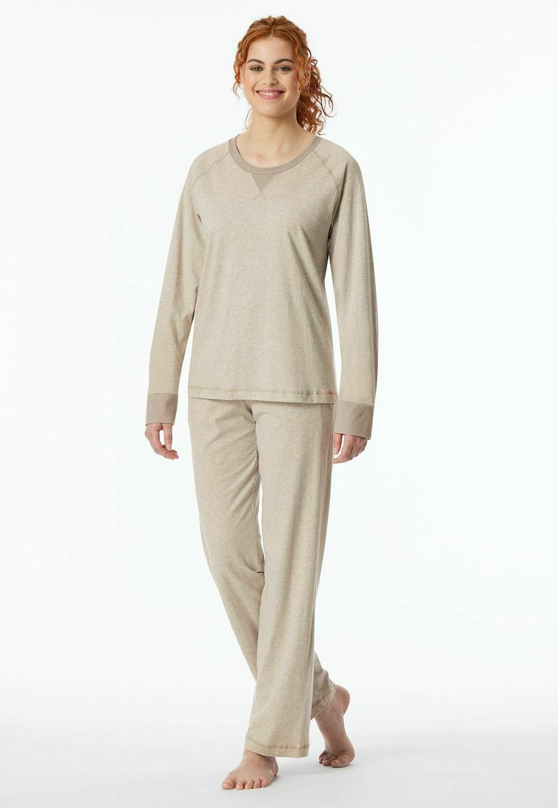 Beige long-sleeve pajama top with ribbed neckline paired with matching pants. Soft, lightweight fabric with a relaxed fit.