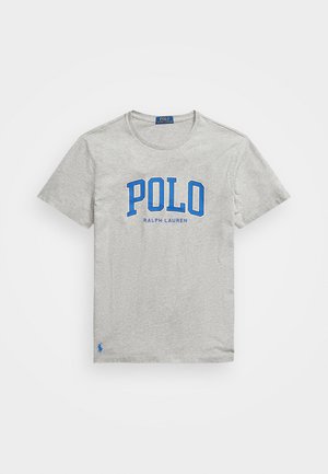 Grå bomulls T-skjorte med en stor blå "POLO" logo og "RALPH LAUREN" under. Korte ermer og rund hals. Liten blå logo ved kanten.