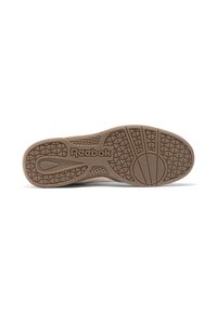 Semelle de chaussure Reebok en caoutchouc beige avec motif texturé antidérapant. Comprend un logo et un design à bout arrondi, offrant stabilité et adhérence.