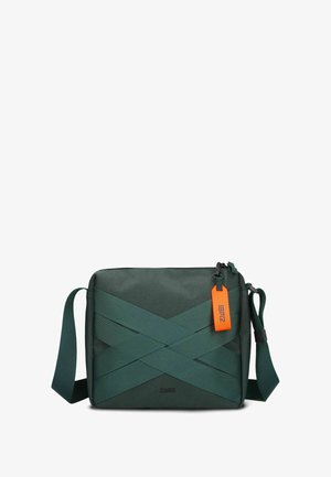 Dark green messenger bag with a textured material, featuring crisscrossing straps and an orange tag. Adjustable shoulder strap attached.