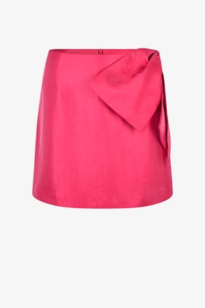 Rožinė lininė sijonas su lygiu paviršiumi, A formos siluetas ir didelis surištas mazgas šone. Turi diskretišką užtrauktuką nugarinėje pusėje.