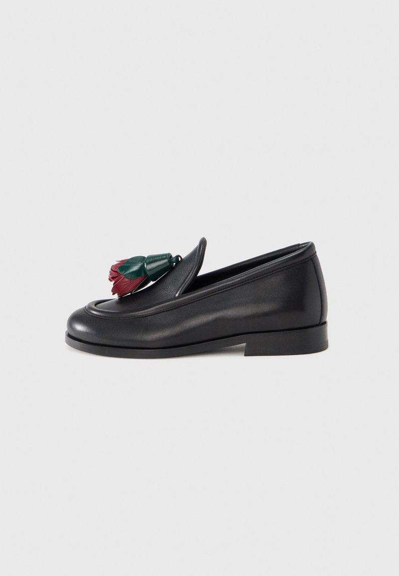 Black leather loafer with a smooth texture, featuring a decorative floral accent in red and green on the upper. Low stacked heel.