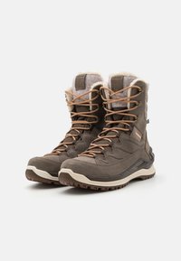 Brown hiking boots with textured fabric and leather upper, tan laces, fur lining at the collar, and a rugged rubber outsole.