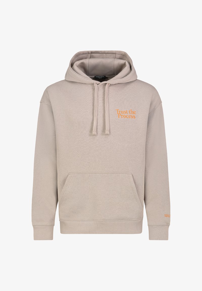 Beige hoodie featuring the phrase "Trust the Process" in orange embroidery, with a kangaroo pocket and drawstring hood.
