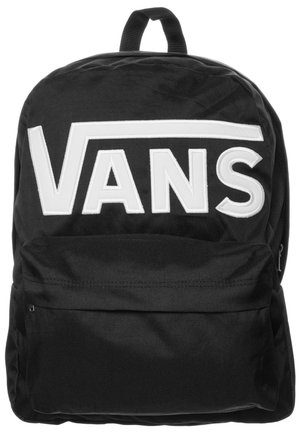 Sac à dos noir avec grand logo blanc "VANS" sur le devant et une poche avant zippée, boucle de transport supérieure visible.