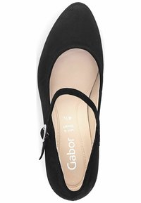 Scarpa Mary Jane nera in suede, con punta rotonda, cinturino regolabile con fibbia argentata e soletto di colore beige chiaro con branding stampato.