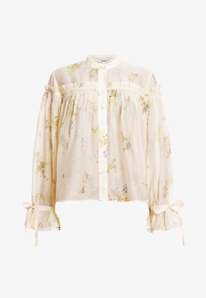 Bluse i kremfarge med blomsterdesign laget av lett stoff. Har høy hals, volanger detaljer og samlede ermer med bånd.