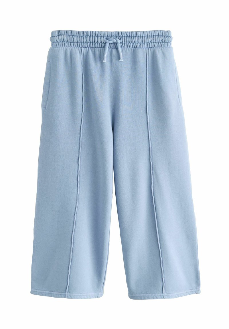 Pantalons de jogging larges bleu clair avec une taille élastique, cordon de serrage, poches latérales et coutures décoratives à l'avant.