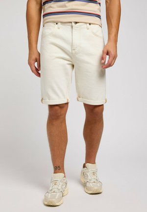 Cream-colored denim shorts with rolled hems, featuring a classic five-pocket design, stitched accents, and a button closure.