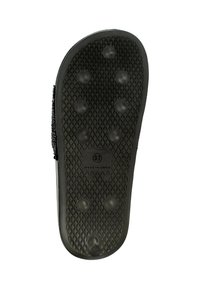 Sole in gomma nera con superficie strutturata dotata di piccoli grip circolari e un'etichetta di taglia "37". Design testurizzato per una migliore trazione.