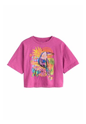 Bright pink short-sleeve t-shirt with colorful toucan, sun, butterfly, flowers, and tropical fruit graphic on front.