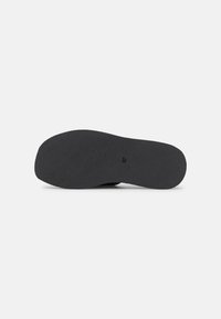 Black shoe sole with a textured surface and rounded toe. Imprinted size 37. Flat design, suitable for various footwear styles.