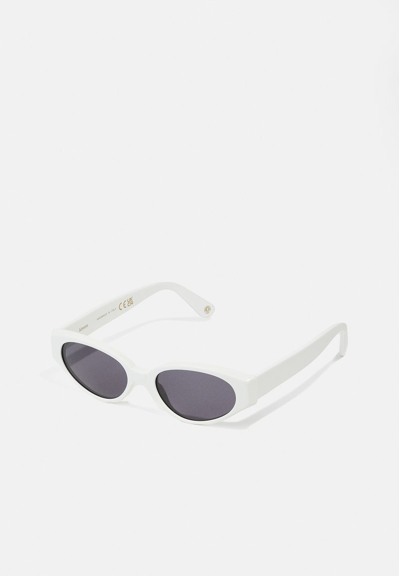 White sunglasses with a sleek, rounded frame and dark lenses. Smooth plastic material with subtle branding on the inner arm.