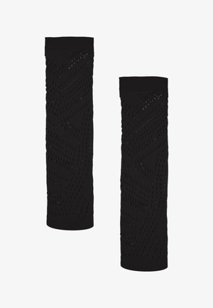 Leg warmers neri con un motivo testurizzato caratterizzato da fori a taglio e polsini a costine; materiale elastico progettato per comfort e flessibilità.