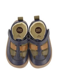 Chaussures en cuir bleu et vert avec des accents en tan, présentant des découpes et un intérieur doux. Comprend un onglet à l'arrière pour un enfilage facile.