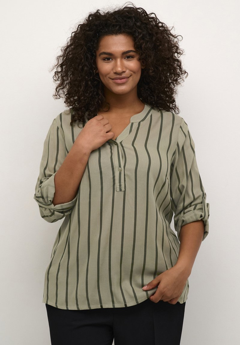 Green striped blouse with a collared neckline, button detail, and rolled-up sleeves. Soft, lightweight fabric with a relaxed fit.