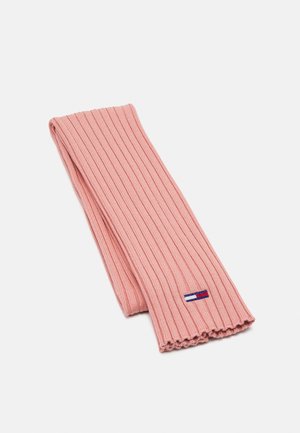 Écharpe en tricot côtelé rose pâle pliée, présentant un petit logo rectangulaire rouge, blanc et bleu près d'une extrémité.