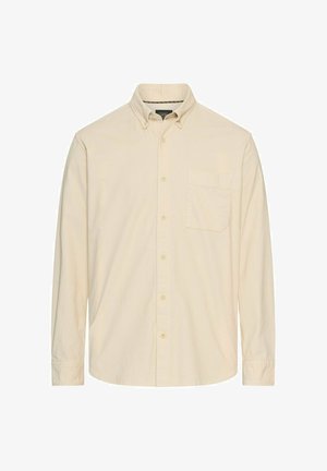 Langærmet skjorte i lys beige stof med knap-ned krave, en brystlomme og frontknaplukning. Subtil tekstur detalje gennem hele.