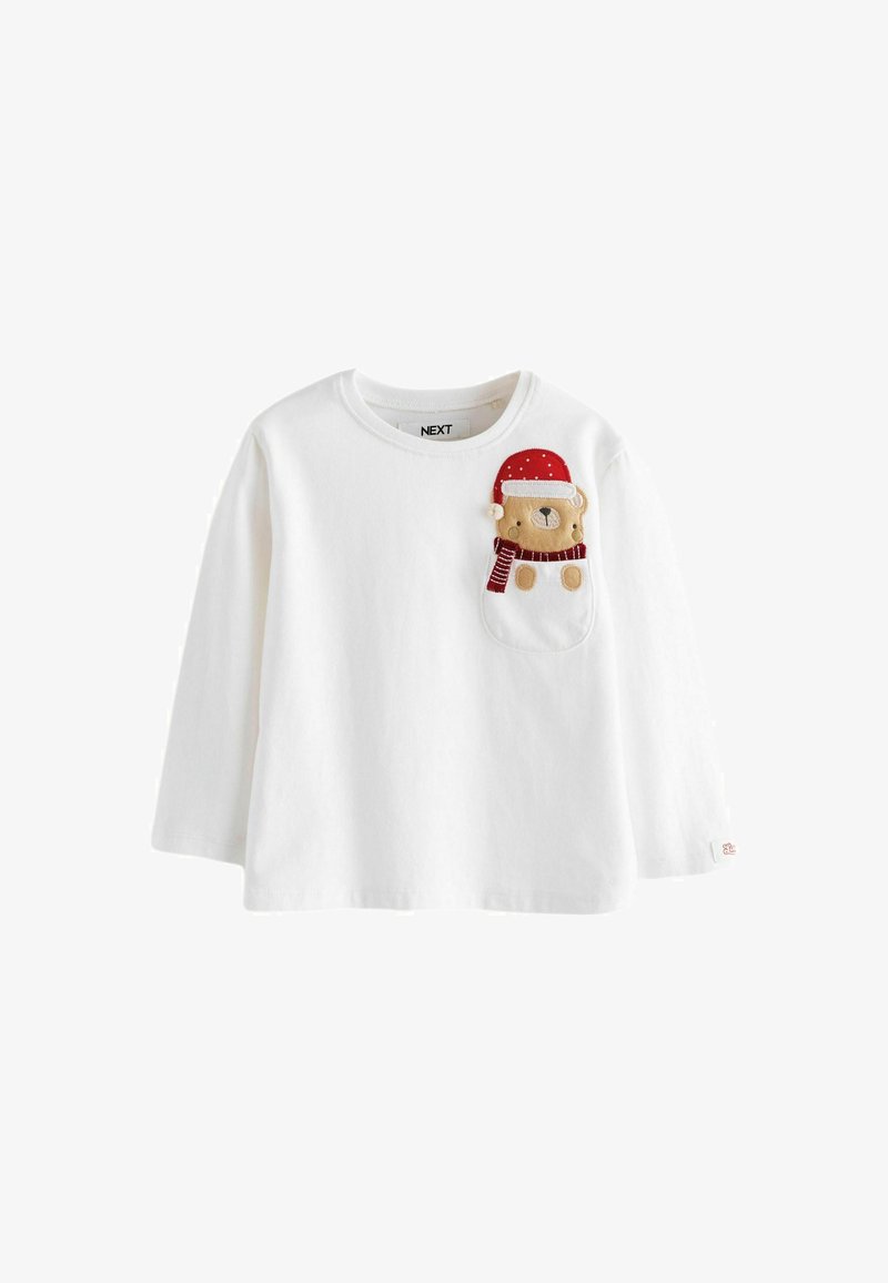 Chemise blanche à manches longues en coton avec un design de poche en forme d'ours. L'ours porte un chapeau rouge à pois blancs et une écharpe rouge.