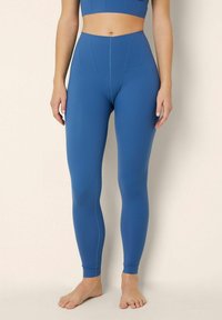 Hooggesneden, full-length leggings in diepblauw, gemaakt van glad, rekbaar materiaal, met een naadloos ontwerp en een aansluitende pasvorm.