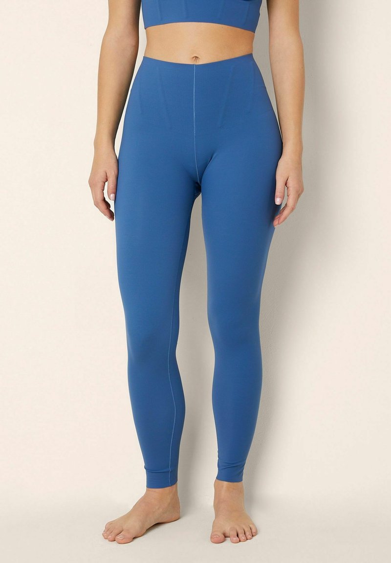 Hooggesneden, full-length leggings in diepblauw, gemaakt van glad, rekbaar materiaal, met een naadloos ontwerp en een aansluitende pasvorm.