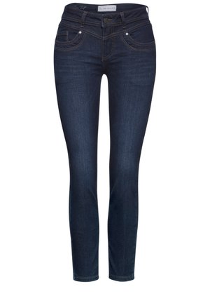Dark blue skinny jeans in denim fabric, featuring a mid-rise waist, five pockets, and subtle contrasting stitching detail.