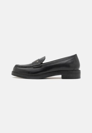 Black leather loafers featuring a moccasin-style stitched toe, flat sole, and subtle hardware detail on the upper. Smooth texture and classic design.