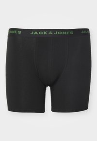 Schwarze Boxer-Shorts aus weichem Stoff, mit einem grünem Logo-Bund und glatter Textur. Enthält verstärktes Nähdetail.