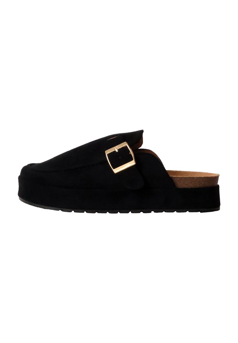 Black suede slip-on shoe with a flat sole, curved design, and a gold buckle detail on the upper. Smooth texture and casual style.