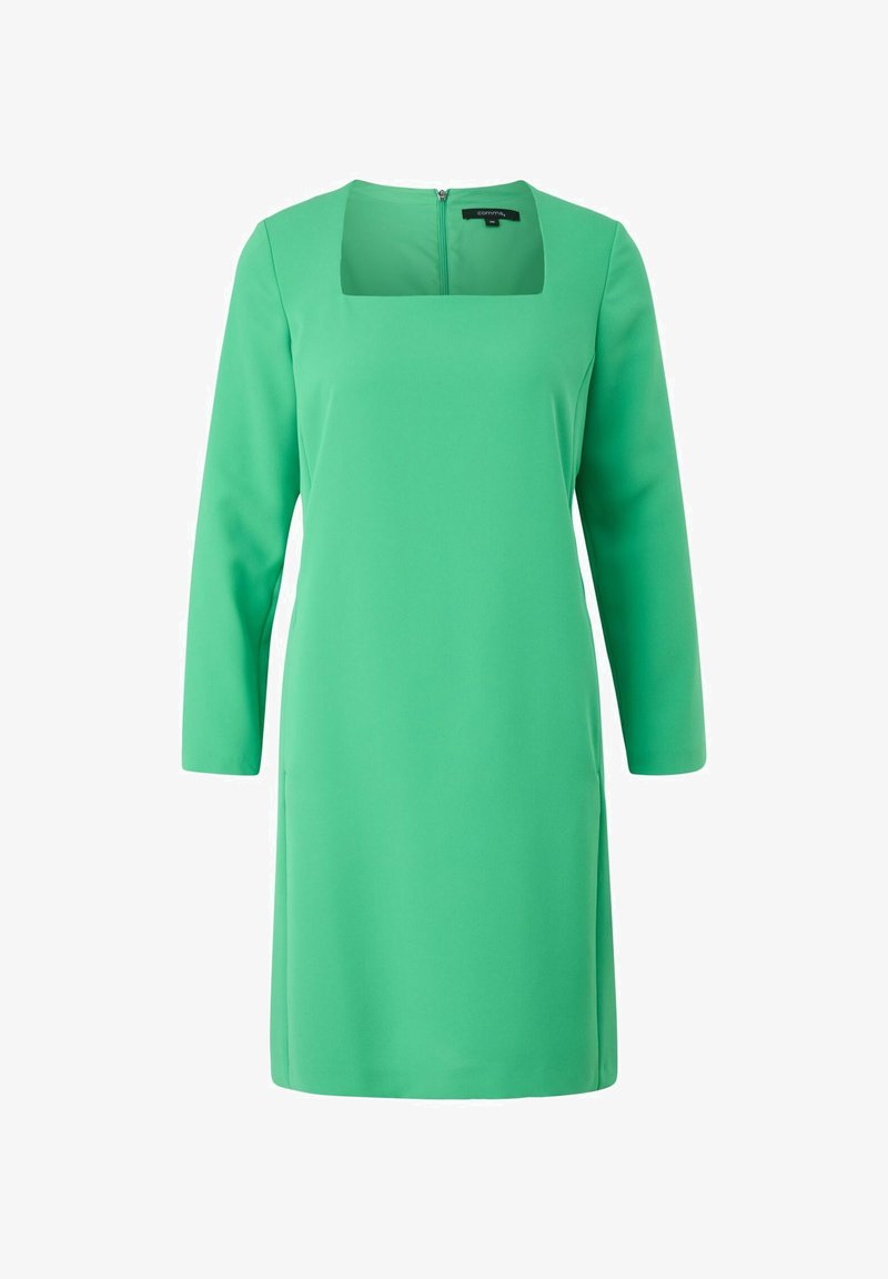 Robe verte à manches longues avec décolleté carré et fermeture éclair au dos ; présente une texture lisse et mate et un design ajusté.