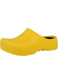 Gelber Clog aus strukturiertem Gummi mit einem rutschfesten Design, rundem Zehenbereich und profiliertem Sohlen für besseren Halt. Keine sichtbaren Beschläge.
