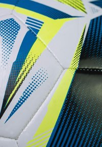 Patterned soccer ball features a white surface with blue, black, and neon yellow accents, featuring geometric shapes and dot gradients.