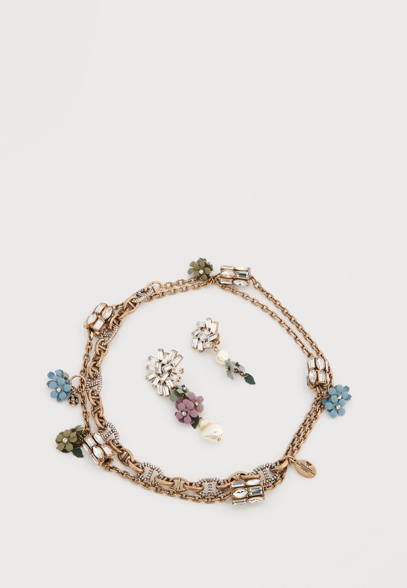 Gold-tone chain necklace with floral accents in blue, green, and purple; includes matching earrings with crystal embellishments.